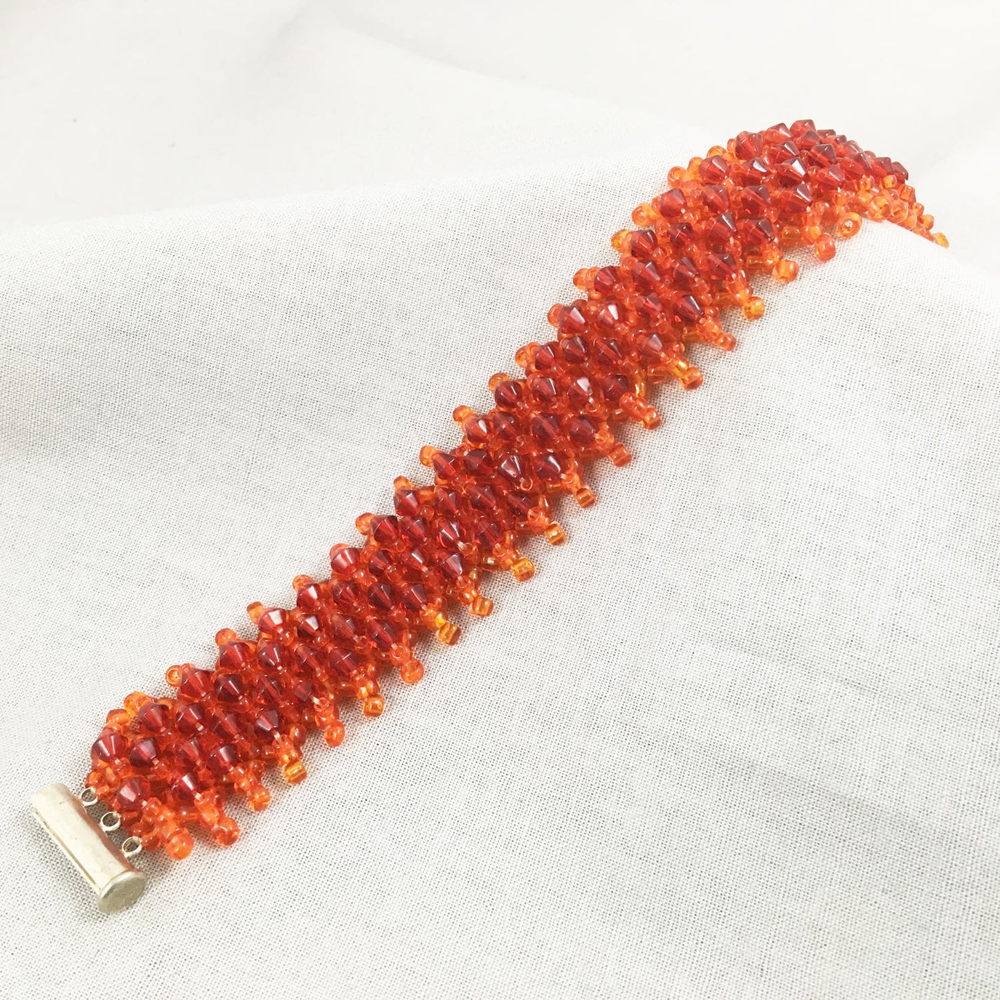 Orange Beaded Bracelet with Red Crystals